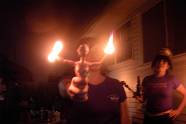 Eli U. holding a burning Barbie doll, New Orleans, Louisiana