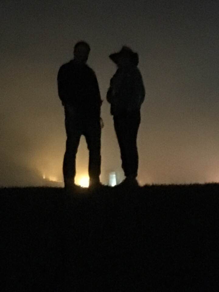 David and Gina standing on the levee on a foggy night