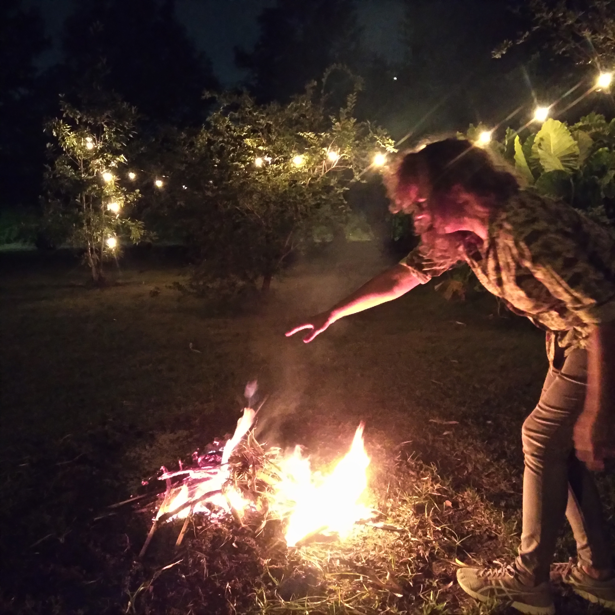 Gina puts leaves on a fire, New Orleans, October 23, 2021.