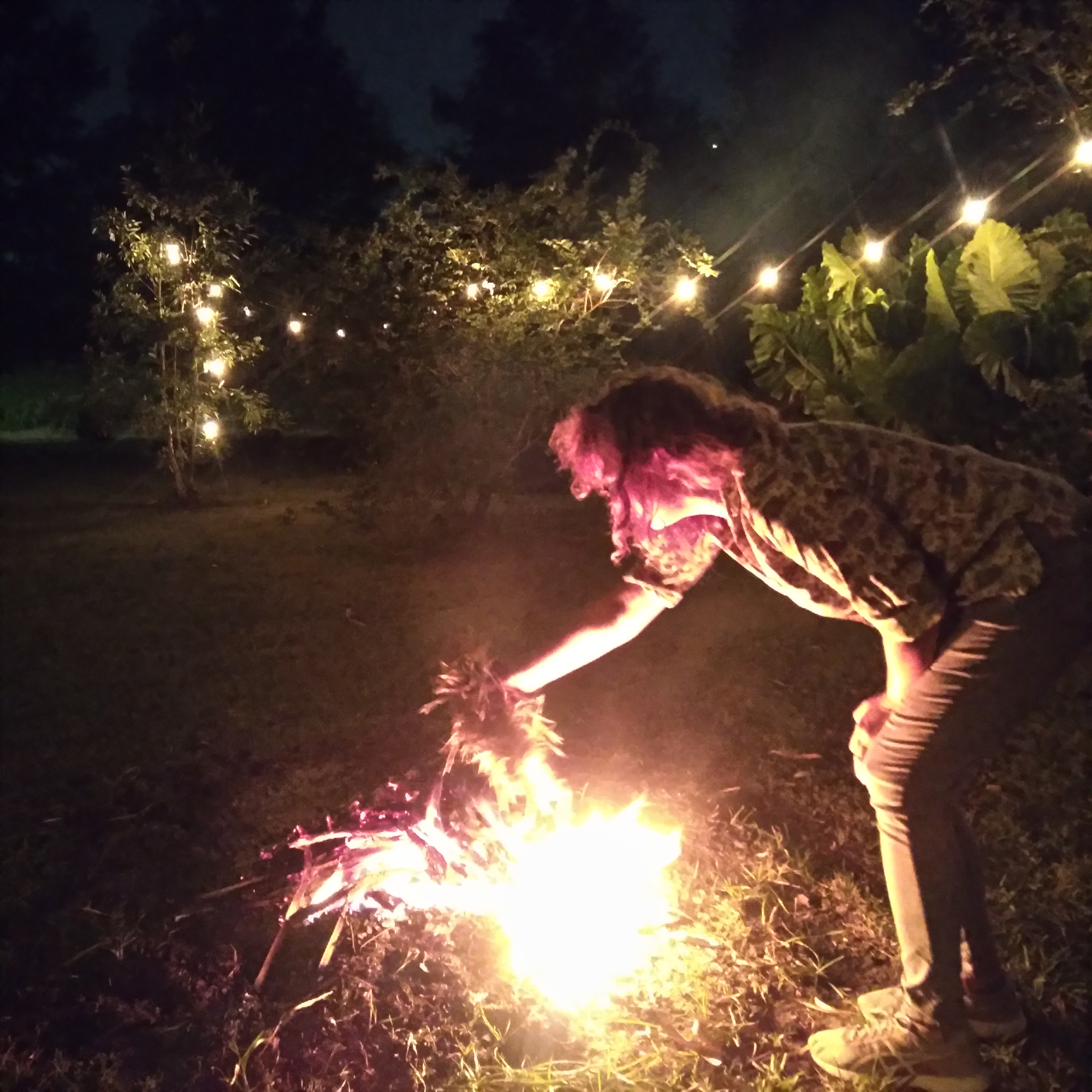  Gina putting leaves on the bonfire.