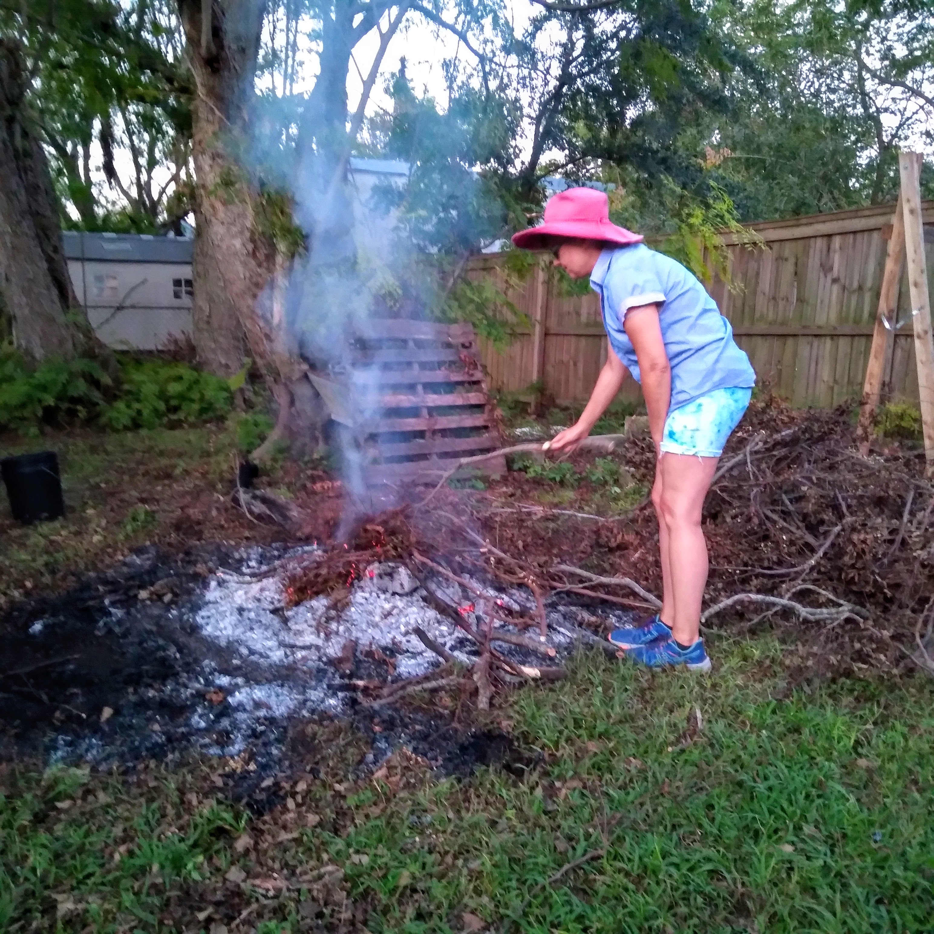 Gina Phillips tends a fire, September 10, 2021.