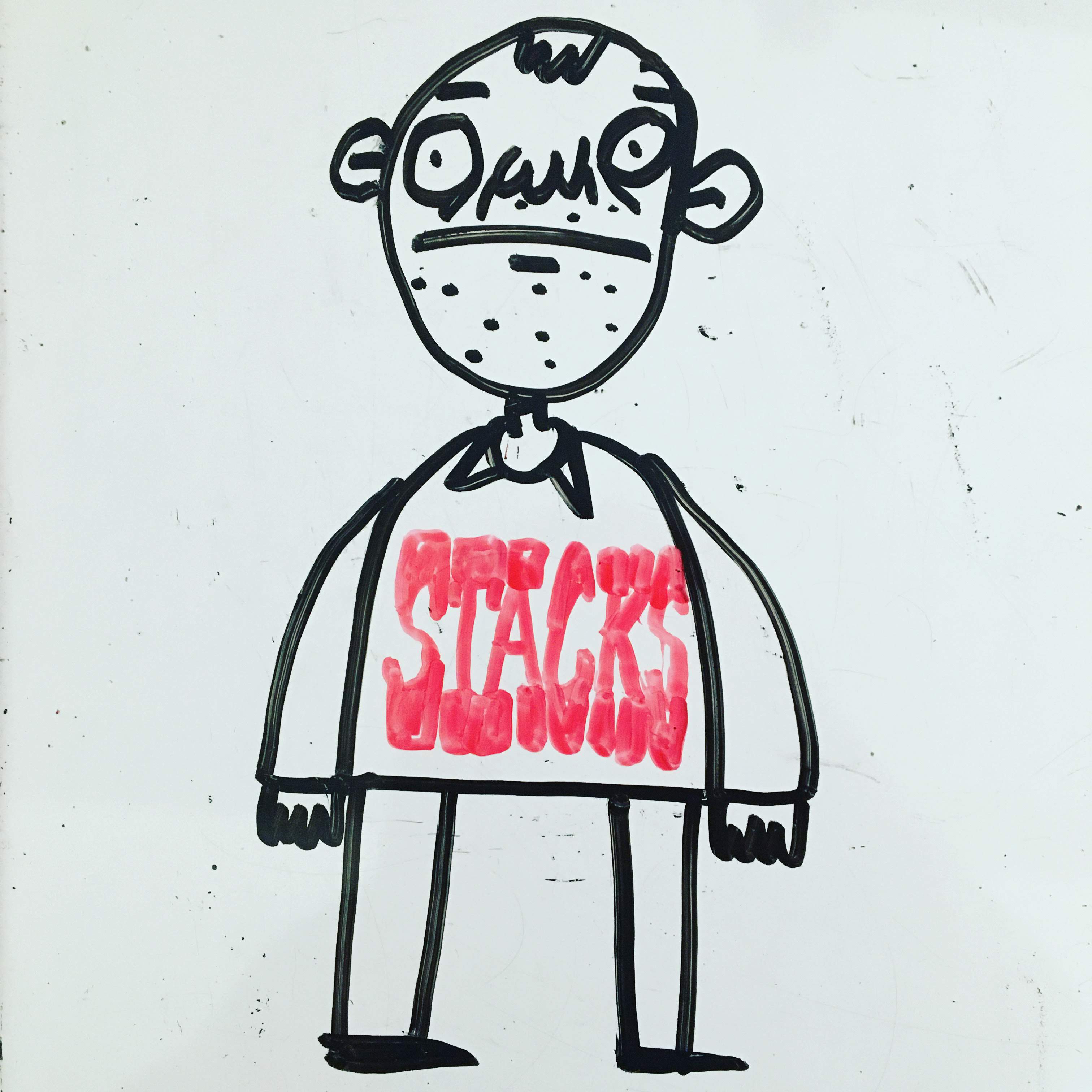 Whiteboard drawing of a guy in a Stacks t-shirt.