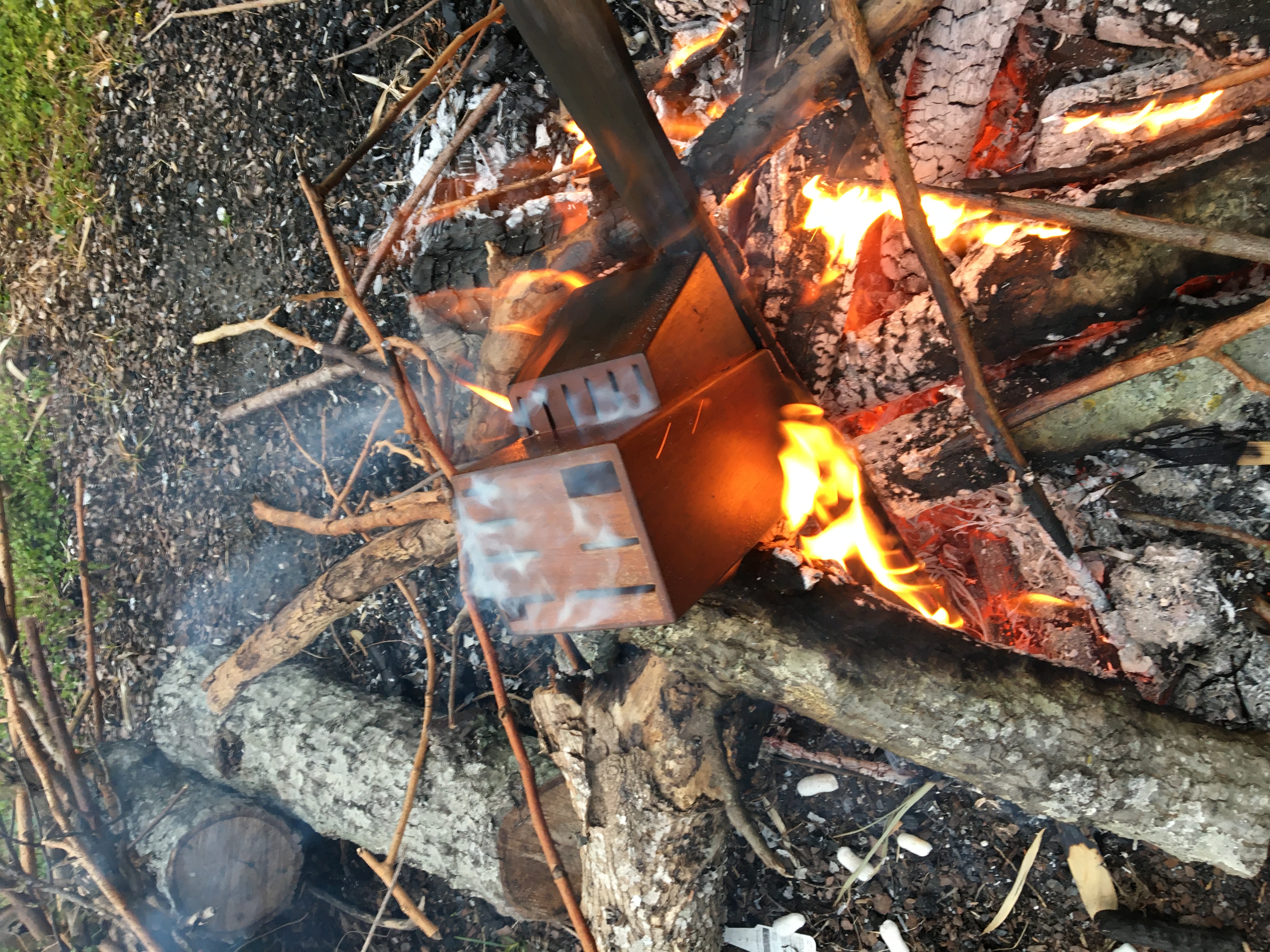 a knifeblock smoking in a bonfire