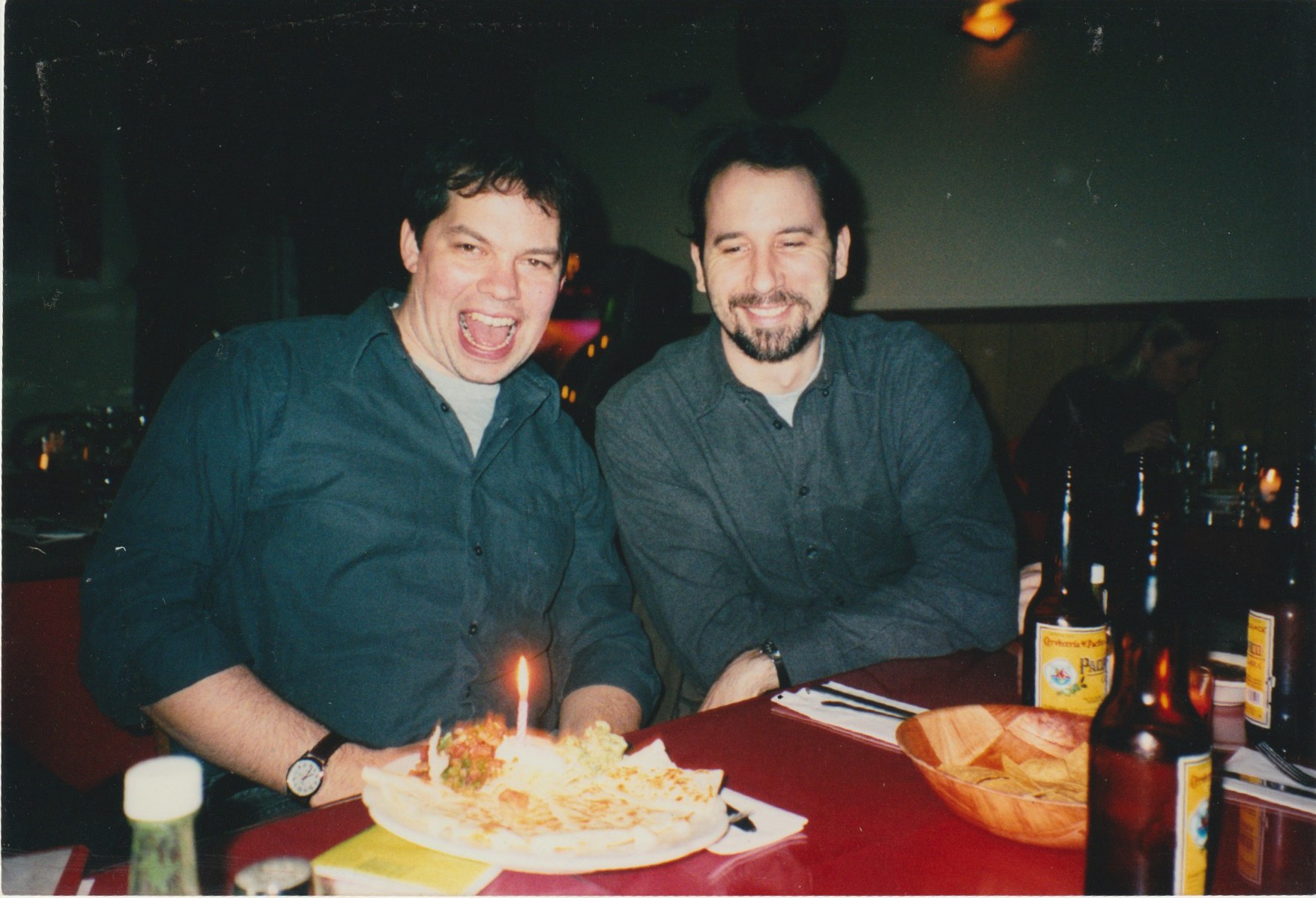 David Rhoden and Alan Dorsey posing with a candle-lit burrito at La Ceiba, March 2, 2003.