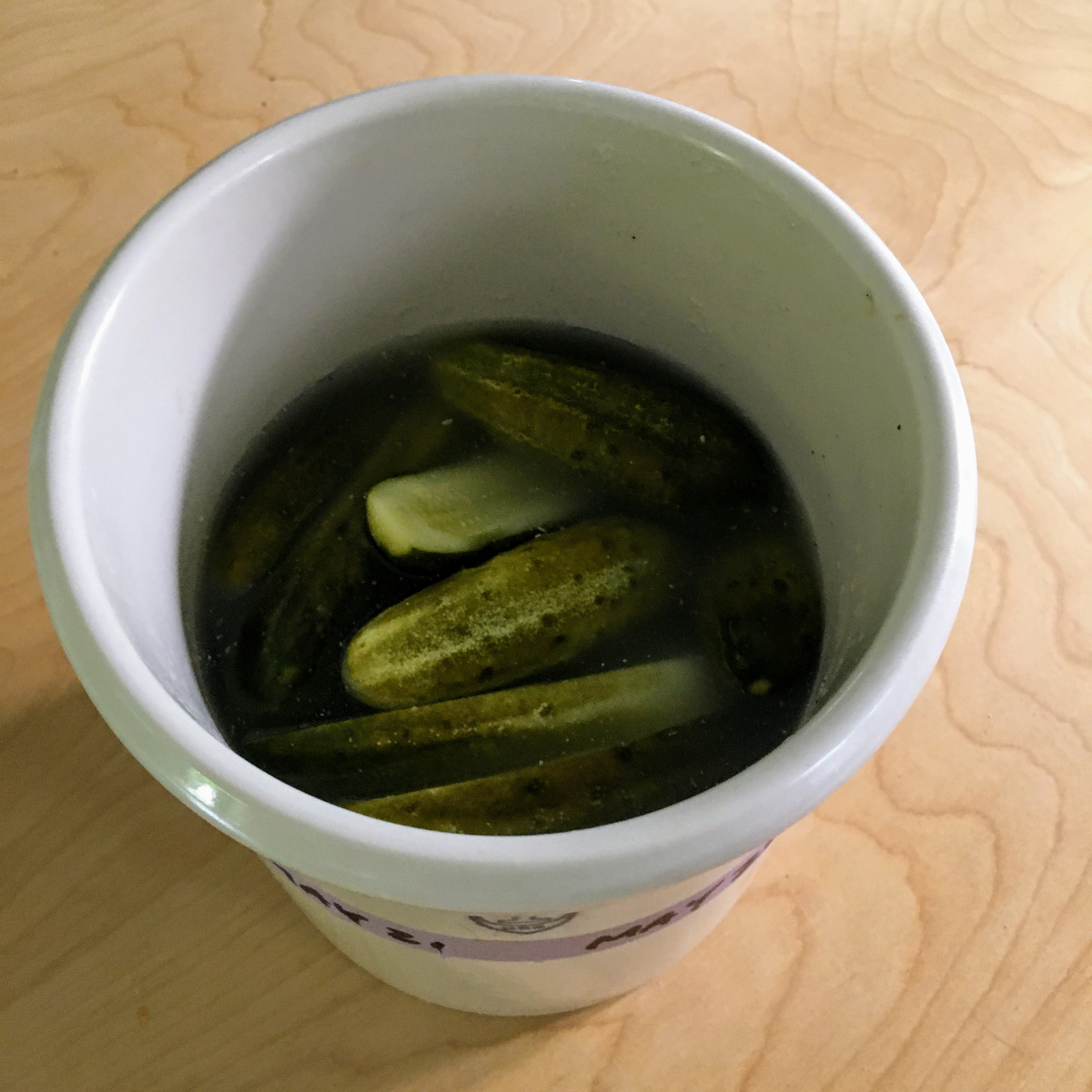 a crock of homemade half-sour pickles