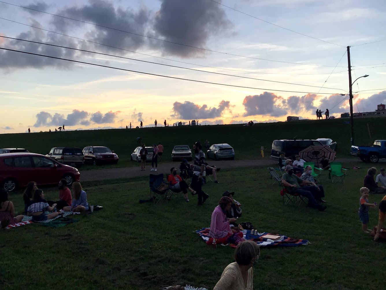 Levee watchers and clouds at Holy Cross Music Hang