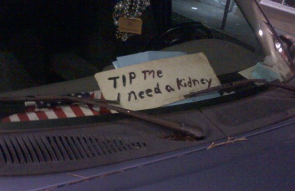 I Need A Kidney placard on dashboard