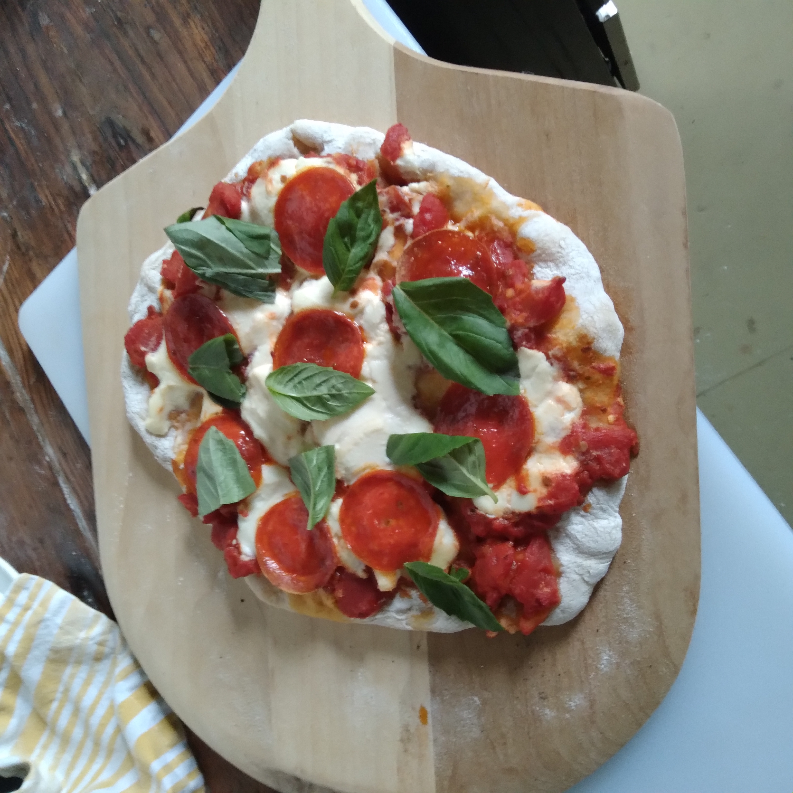 Pizza topped with ricotta and basil.