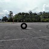 I photographed a standing tire in the Holy Cross school parking lot.