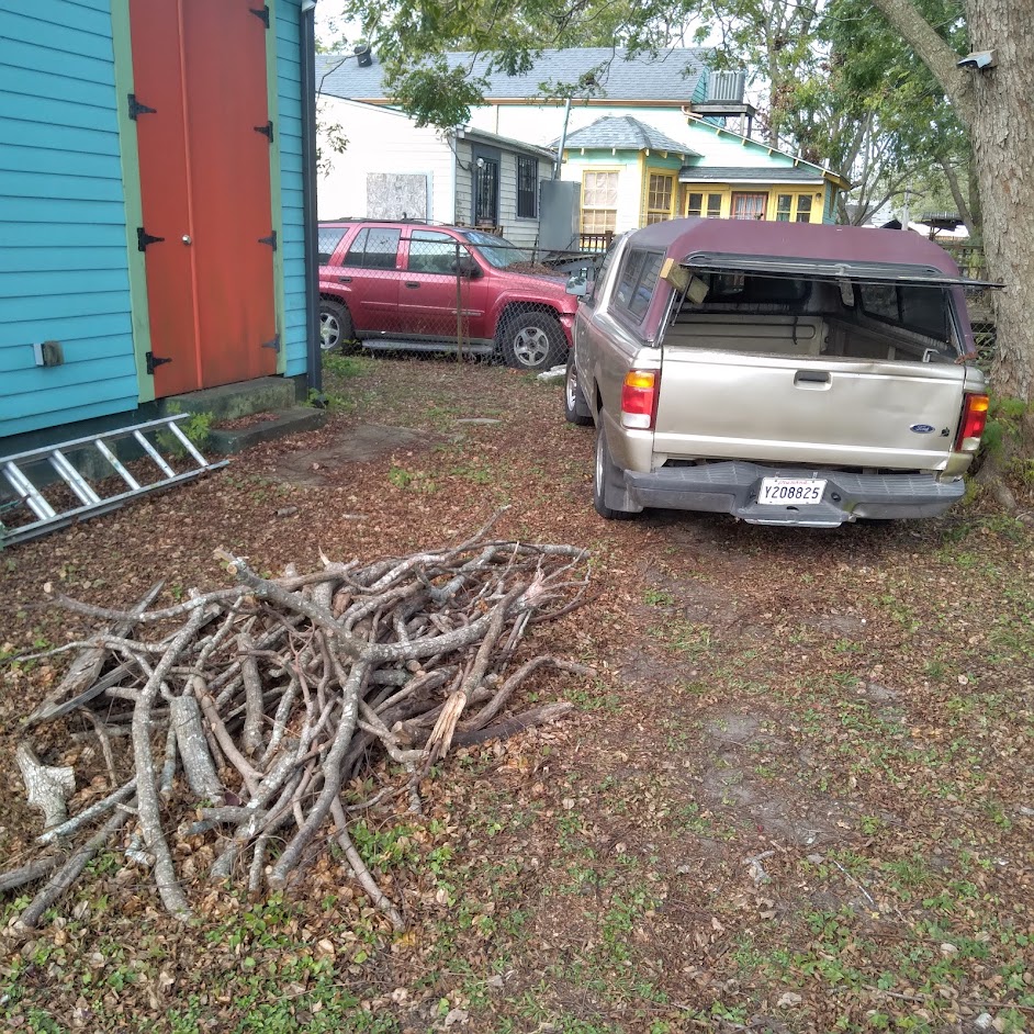 Goldie the Truck in the yard picking up wood